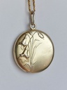 Art Nouveau silver pendant with a gold wash and repoussé flowers